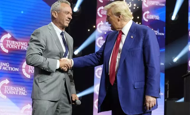 FILE - Republican presidential nominee former President Donald Trump greets Robert F. Kennedy Jr., at a Turning Point Action campaign rally, Oct. 23, 2024, in Duluth, Ga. (AP Photo/Alex Brandon)