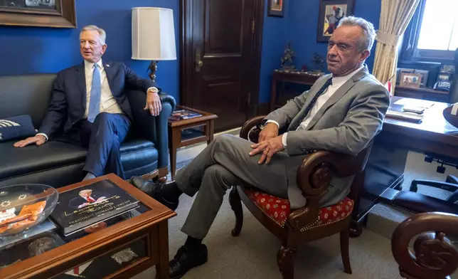 Robert Kennedy Jr., right, President-elect Donald Trump's pick to lead the Health and Human Services Department, meets with Sen. Tommy Tuberville, R-Ala., on Capitol Hill, Tuesday, Dec. 17, 2024, in Washington. (AP Photo/Mark Schiefelbein)