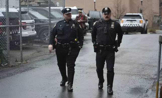 New York Police officers arrive at Altoona Police Department, where a man with a gun thought to be similar to the one used in the killing of UnitedHealthcare CEO Brian Thompson has been taken into police custody for questioning, Monday, Dec. 9, 2024, in Altoona, Pa. (AP Photo/Gene J. Puskar)