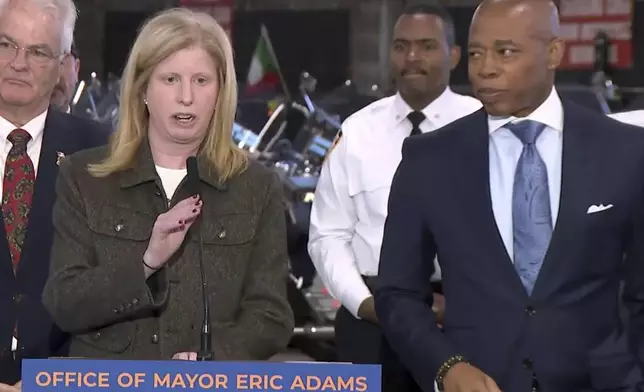 This image from video provided by Office of the New York Mayor shows New York City Police Commissioner Jessica Tisch, with New York Mayor Eric Adams, right, in the Staten Island borough of New York, Wednesday, Dec. 11, 2024, as she says the gun found on the suspect in the killing of United Healthcare's CEO matched shell casings found at the site of the shooting, and the suspect's fingerprints also matched a water bottle and a snack bar wrapper that police found near the scene in midtown Manhattan. (Office of the New York Mayor via AP)