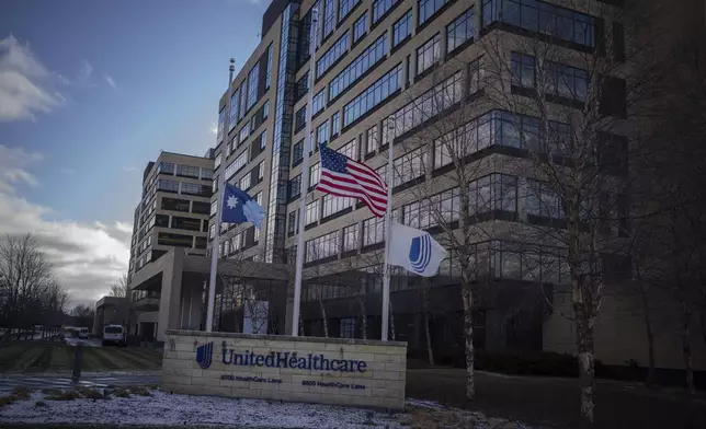 Flags fly at half mast in front of UnitedHealthcare headquarters in Minnetonka, Minn., Wednesday Dec. 4, 2024, after its CEO Brian Thompson was shot and killed in New York City. (Jerry Holt/Star Tribune via AP)