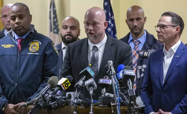 Blair County, Pa., District Attorney Peter Weeks, center, speaks during a press conference regarding the arrest of suspect Luigi Mangione, Monday, Dec. 9, 2024, in Hollidaysburg, Pa., in the fatal shooting of UnitedHealthcare CEO Brian Thompson. (AP Photo/Ted Shaffrey)