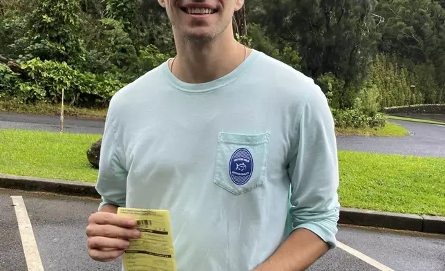 This photo, provided by the Hawaii Dept. of Land and Natural Resources, shows Luigi Mangione, a suspect in the fatal shooting of UnitedHealthcare CEO Brian Thompson, receiving a citation for failing to observe a posted closed-area sign, in Honolulu, Sunday, Nov. 12, 2023. (Hawaii Dept. of Land and Natural Resources via AP)