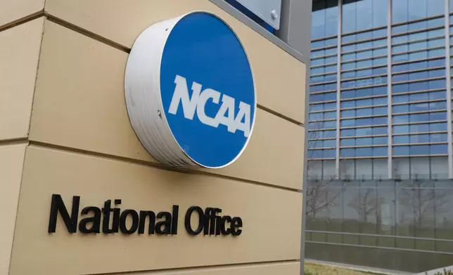 FILE - Signage at the headquarters of the NCAA is viewed in Indianapolis, March 12, 2020. A U.S. appeals court in Philadelphia has ruled that some college athletes may qualify as employees under federal wage-and-hour laws. The court says a test should be developed to differentiate students who play college sports for fun from those whose effort "crosses the legal line into work" that benefits the school. The NCAA had hoped to have the case dismissed.(AP Photo/Michael Conroy, File)