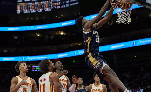 New Orleans Pelicans center Yves Missi (21) dunks against the Atlanta Hawks during the first half of an NBA basketball game, Monday, Dec. 2, 2024, in Atlanta. (AP Photo/Mike Stewart)