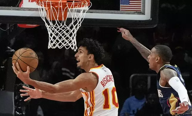 Atlanta Hawks forward Zaccharie Risacher (10) shoots against the New Orleans Pelicans during the first half of an NBA basketball game, Monday, Dec. 2, 2024, in Atlanta. (AP Photo/Mike Stewart)