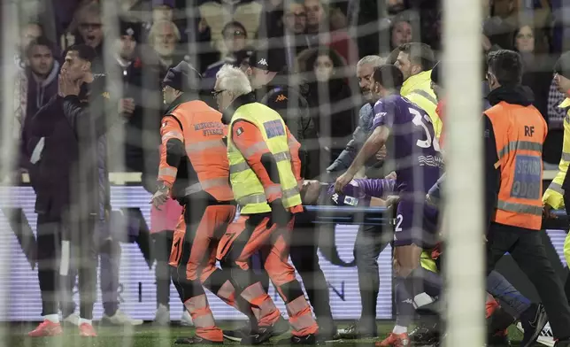 Fiorentina's Edoardo Bove, injured, is transported to a waiting ambulance during the Serie A soccer match between Fiorentina and Inter at the Artemio Franchi Stadium in Florence, Italy, Sunday Dec. 1, 2024. The match was suspended and finally postponed as the injures appeared to be serious. (Massimo Paolone/LaPresse via AP)