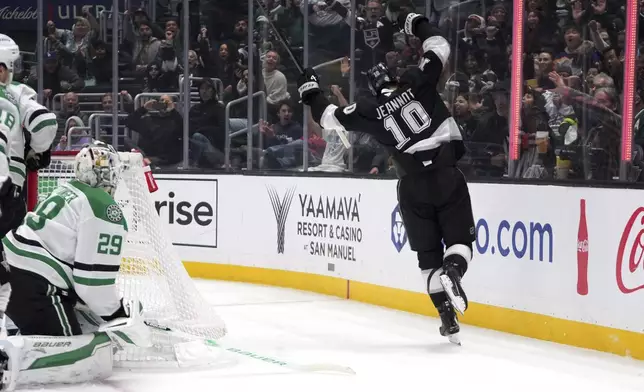 Los Angeles Kings left wing Tanner Jeannot, right, celebrates after scoring on Dallas Stars goaltender Jake Oettinger, left, during the second period of an NHL hockey game, Wednesday, Dec. 4, 2024, in Los Angeles. (AP Photo/Mark J. Terrill)