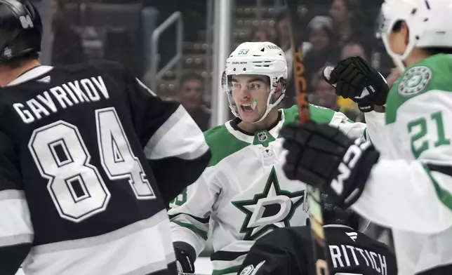 Dallas Stars center Wyatt Johnston, second from left, celebrates his goal as Los Angeles Kings goaltender David Rittich, second from right, looks on during the first period of an NHL hockey game, Wednesday, Dec. 4, 2024, in Los Angeles. (AP Photo/Mark J. Terrill)