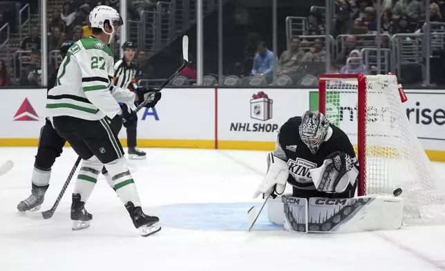 Los Angeles Kings goaltender David Rittich, right, deflects a shot by Dallas Stars left wing Mason Marchment during the first period of an NHL hockey game, Wednesday, Dec. 4, 2024, in Los Angeles. (AP Photo/Mark J. Terrill)