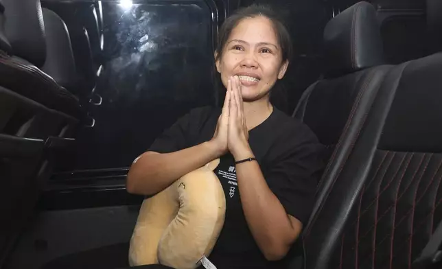 Filipino death row inmate Mary Jane Veloso gestures to the media as she leaves Yogyakarta Women's Prison for her transfer to the capital city of Jakarta in preparation for her repatriation to the Philippines, in Gunung Kidul, Indonesia, Sunday, Dec. 15, 2024. (AP Photo/Slamet Riyadi)