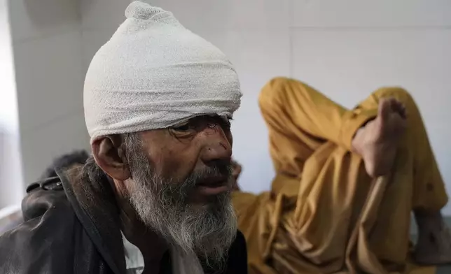 Afghan men who were injured in a bus accident rest in a hospital in Ghazni province, southeastern Afghanistan, Thursday, Dec. 19, 2024. (AP Photo/Gulabuddin Amiri)