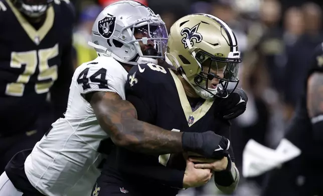 Las Vegas Raiders defensive end K'Lavon Chaisson (44) sacks New Orleans Saints quarterback Spencer Rattler during the second half of an NFL football game, Sunday, Dec. 29, 2024, in New Orleans. (AP Photo/Butch Dill)