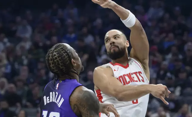 Houston Rockets forward Dillon Brooks passes over Sacramento Kings forward DeMar DeRozan (10) during the first half of an Emirates NBA Cup basketball game in Sacramento, Calif., Tuesday, Dec. 3, 2024. (AP Photo/Randall Benton)