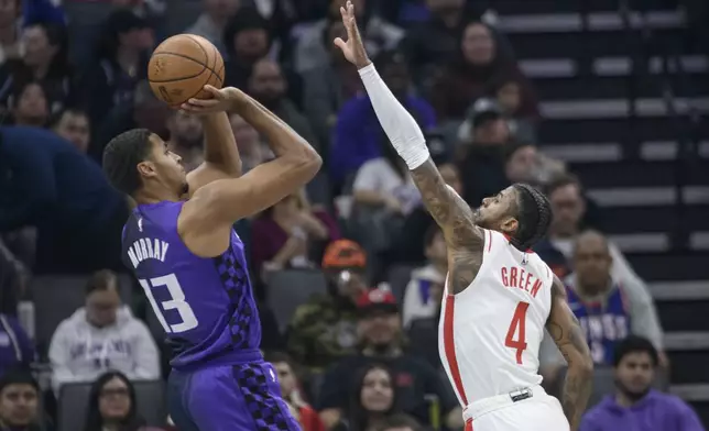 Sacramento Kings forward Keegan Murray (13) shoots over Houston Rockets guard Jalen Green (4) during the first half of an Emirates NBA Cup basketball game in Sacramento, Calif., Tuesday, Dec. 3, 2024. (AP Photo/Randall Benton)