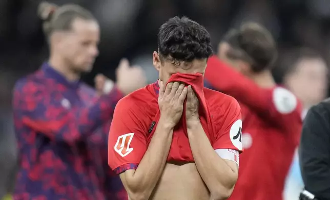 Sevilla's Jesus Navas covers his eyes on his career's last game at the end of the Spanish La Liga soccer match between Real Madrid and Sevilla at the Santiago Bernabeu Stadium in Madrid, Spain, Sunday, Dec. 22, 2024. (AP Photo/Bernat Armangue)