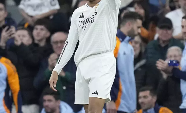 Real Madrid's Kylian Mbappe celebrates after scoring the opening goal during the Spanish La Liga soccer match between Real Madrid and Sevilla at the Santiago Bernabeu Stadium in Madrid, Spain, Sunday, Dec. 22, 2024. (AP Photo/Bernat Armangue)