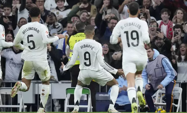 Real Madrid's Kylian Mbappe celebrates after scoring the opening goal during the Spanish La Liga soccer match between Real Madrid and Sevilla at the Santiago Bernabeu Stadium in Madrid, Spain, Sunday, Dec. 22, 2024. (AP Photo/Bernat Armangue)