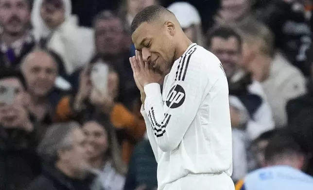 Real Madrid's Kylian Mbappe celebrates after scoring the opening goal during the Spanish La Liga soccer match between Real Madrid and Sevilla at the Santiago Bernabeu Stadium in Madrid, Spain, Sunday, Dec. 22, 2024. (AP Photo/Bernat Armangue)