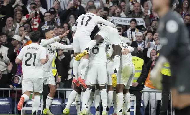 Real Madrid's Federico Valverde celebrates with his teammates after scoring his side's second goal during the Spanish La Liga soccer match between Real Madrid and Sevilla at the Santiago Bernabeu Stadium in Madrid, Spain, Sunday, Dec. 22, 2024. (AP Photo/Bernat Armangue)