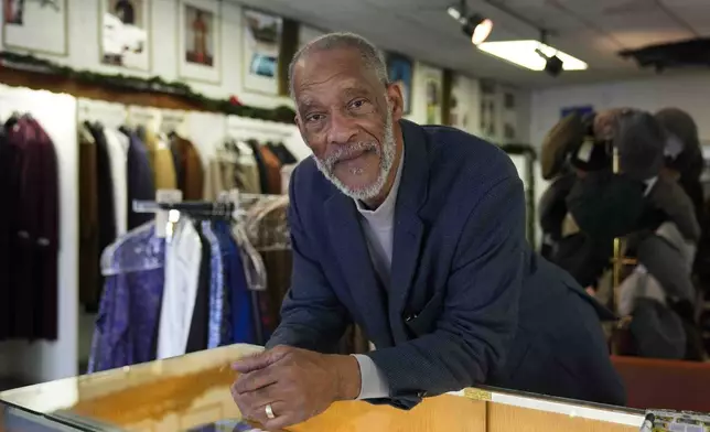 Ledall Edwards stands inside his family's men's clothing store, Edward's Fashions, which his father opened 50 years ago with the hopes of a southern Red Line train line expansion, Thursday, Dec. 19, 2024, in the Roseland neighborhood of Chicago. (AP Photo/Erin Hooley)