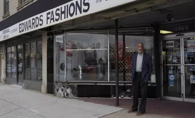 Ledall Edwards stands outside his family's men's clothing store, Edward's Fashions, which his father opened 50 years ago with the hopes of a southern Red Line train line expansion, Thursday, Dec. 19, 2024, in the Roseland neighborhood of Chicago. (AP Photo/Erin Hooley)