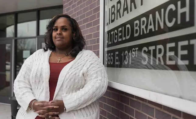 Adella Bass, health equity director with the People for Community Recovery environmental organization, stands outside the branch of the Chicago Public Library on the far South Side in the Altgeld Gardens community where she lives and works, Thursday, Dec. 19, 2024, in Chicago, where the Chicago Transit Authority plans to expand the Red Line train route. (AP Photo/Erin Hooley)