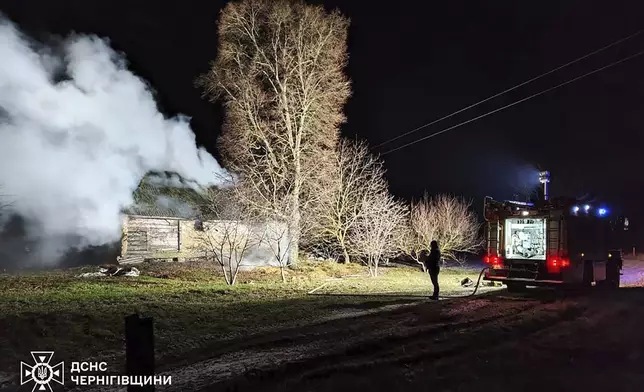 In this photo provided by the Ukrainian Emergency Service, firefighters work on the site of a damaged building after a Russian drone attack in Chernihiv region, Ukraine, early Friday, Dec. 13, 2024. (Ukrainian Emergency Service via AP Photo)