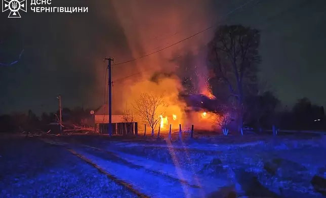 In this photo provided by the Ukrainian Emergency Service, burning buildings are seen on site after a Russian drone attack in Chernihiv region, Ukraine, early Friday, Dec. 13, 2024. (Ukrainian Emergency Service via AP Photo)