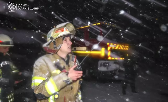 In this photo provided by the Ukrainian Emergency Service, firefighters work on the site of a damaged building after a Russian drone attack in Kharkiv, Ukraine, early Friday, Dec. 13, 2024. (Ukrainian Emergency Service via AP Photo)