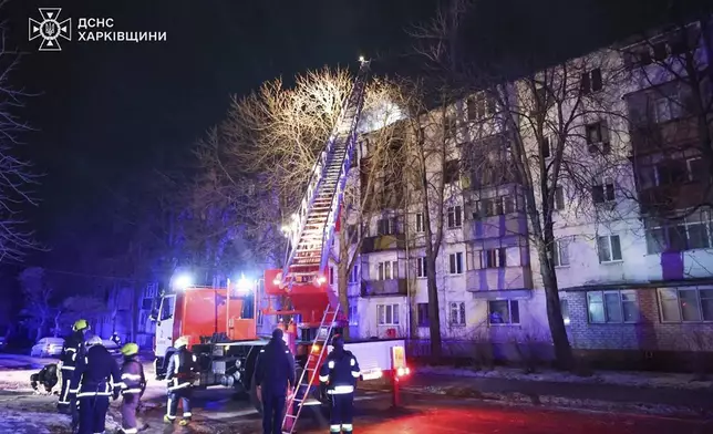 In this photo provided by the Ukrainian Emergency Service, firefighters work on the site of a damaged building after a Russian drone attack in Kharkiv, Ukraine, early Friday, Dec. 13, 2024. (Ukrainian Emergency Service via AP Photo)