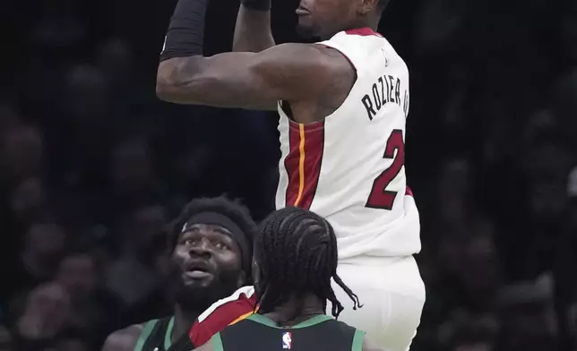 Miami Heat guard Terry Rozier (2) looks to pass the ball against Boston Celtics guard Jaylen Brown (7) during the first half of an NBA basketball game, Monday, Dec. 2, 2024, in Boston. (AP Photo/Charles Krupa)