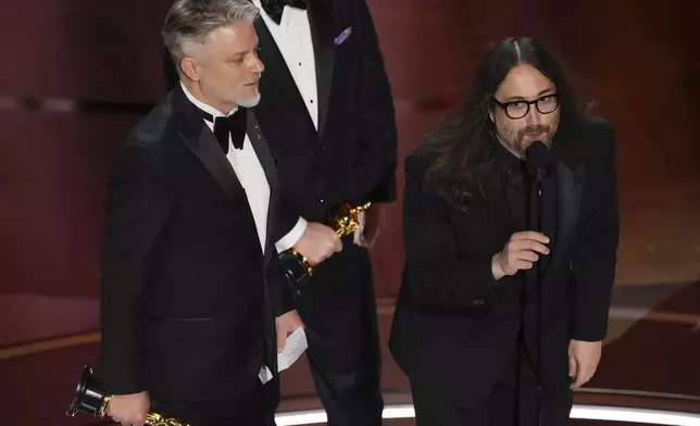 FILE - Dave Mullins, left, and Sean Ono Lennon accept the award for best animated short for "War Is Over! Inspired by the Music of John &amp; Yoko" during the Oscars on March 10, 2024, in Los Angeles. (AP Photo/Chris Pizzello, File)