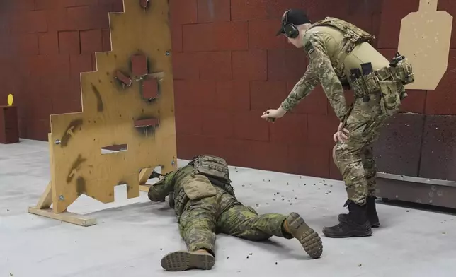 Members of the Vantaa Reservists Association practice at a shooting range in a warehouse in Kerava on the outskirts of Helsinki, Finland, Monday, Dec. 2, 2024. (AP Photo/James Brooks)