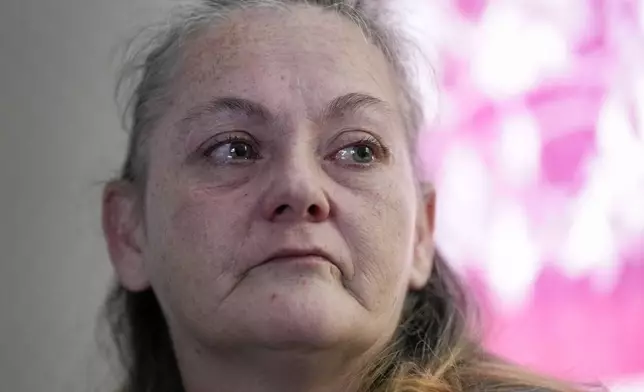 Zinnia Adkins reflects on her experience during Hurricane Helene in September at her home on Nov. 22, 2024, in Unicoi, Tenn. Adkins escaped flood waters at the plastics factory where she worked. (AP Photo/George Walker IV)