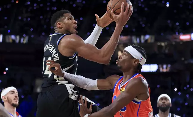 Milwaukee Bucks forward Giannis Antetokounmpo (34) shoots against Oklahoma City Thunder guard Shai Gilgeous-Alexander (2) during the second half of the championship game in the NBA Cup basketball tournament Tuesday, Dec. 17, 2024, in Las Vegas. (AP Photo/Ian Maule)