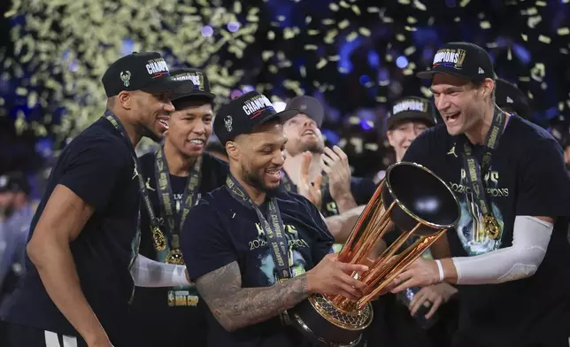 Milwaukee Bucks forward Giannis Antetokounmpo (34), Milwaukee Bucks guard Damian Lillard (0), and Milwaukee Bucks center Brook Lopez (11) celebrate after their team's victory in the championship game of the NBA Cup basketball tournament against the Oklahoma City Thunder Tuesday, Dec. 17, 2024, in Las Vegas. (AP Photo/Ian Maule)