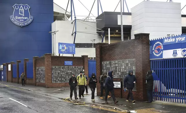 People walk outside Goodison Park as the Premier League soccer match between Everton and Liverpool is called off due to storm Darragh at Goodison Park, in Liverpool, England, Saturday Dec 7, 2024. (AP Photo/Rui Vieira)
