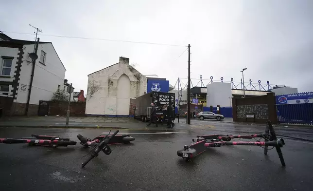 Scooters lie on the ground near the entrance of Goodison Park after the Merseyside derby between Everton and Liverpool was postponed because of adverse weather, in Liverpool, England, Saturday, Dec. 7, 2024. (Peter Byrne/PA via AP)