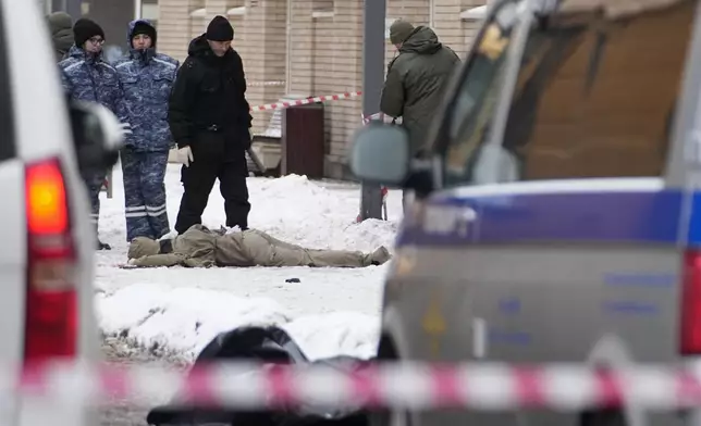 Investigators work at the place where Lt. General Igor Kirillov, the head of Russia's Nuclear, Biological, and Chemical Defence Forces and his assistant, seen at lower center, were killed by an explosive device planted close to a residential apartment's block in Moscow, Russia, Tuesday, Dec. 17, 2024. (AP Photo)