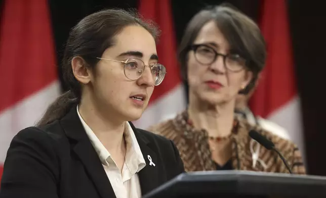 Director of legal affairs at the National Association of Women and the Law, Suzanne Zaccour, left, speaks at a press conference on new measures to strengthen gun control as gun control advocate and survivor of the 1989 Ecole Polytechnique massacre Nathalie Provost listens in Ottawa, Ontario, on Thursday, Dec. 5, 2024. (Patrick Doyle/The Canadian Press via AP)