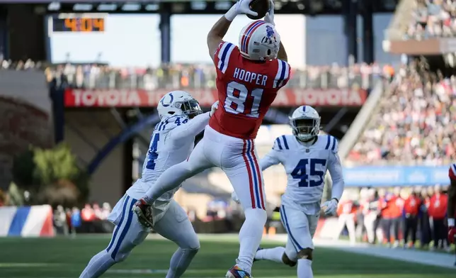 New England Patriots tight end Austin Hooper (81) makes a touchdown reception against Indianapolis Colts linebackers Zaire Franklin (44) and E.J. Speed (45) during the first half of an NFL football game, Sunday, Dec. 1, 2024, in Foxborough, Mass. (AP Photo/Charles Krupa)