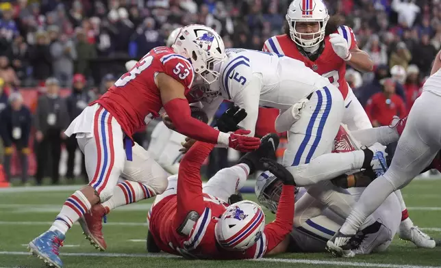 Indianapolis Colts quarterback Anthony Richardson (5) enters the end zone to complete a two-point conversion as New England Patriots linebacker Christian Elliss (53) defends during the second half of an NFL football game, Sunday, Dec. 1, 2024, in Foxborough, Mass. (AP Photo/Steven Senne)