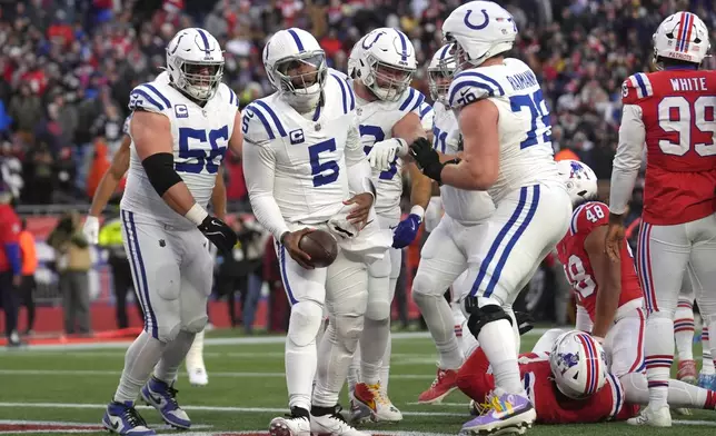 Indianapolis Colts quarterback Anthony Richardson (5) celebrates with guard Quenton Nelson (56) and offensive tackle Bernhard Raimann (79) after completing a two-point conversion during the second half of an NFL football game against the New England Patriots, Sunday, Dec. 1, 2024, in Foxborough, Mass. (AP Photo/Steven Senne)