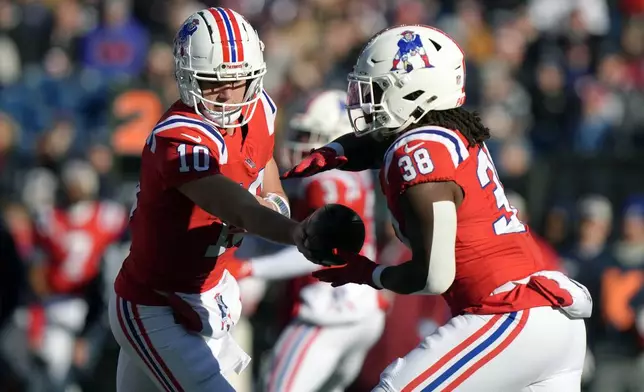 New England Patriots quarterback Drake Maye (10) passes off to running back Rhamondre Stevenson (38) during the first half of an NFL football game, Sunday, Dec. 1, 2024, in Foxborough, Mass. (AP Photo/Steven Senne)