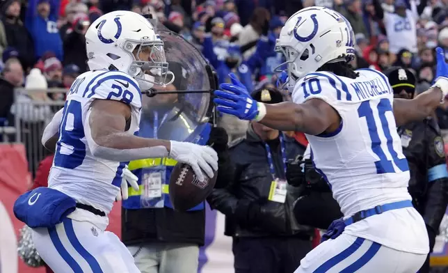 Indianapolis Colts running back Jonathan Taylor (28) celebrates his touckdown with wide receiver Adonai Mitchell (10) during the first half of an NFL football game against the New England Patriots, Sunday, Dec. 1, 2024, in Foxborough, Mass. (AP Photo/Steven Senne)