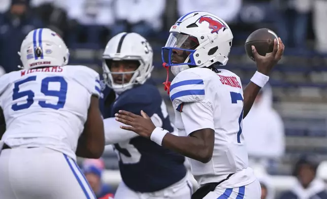 SMU quarterback Kevin Jennings (7) throws a pass while being pressured by Penn State defensive end Dani Dennis-Sutton (33) during the first half in the first round of the College Football Playoff, Saturday, Dec. 21, 2024, in State College, Pa. (AP Photo/Barry Reeger)