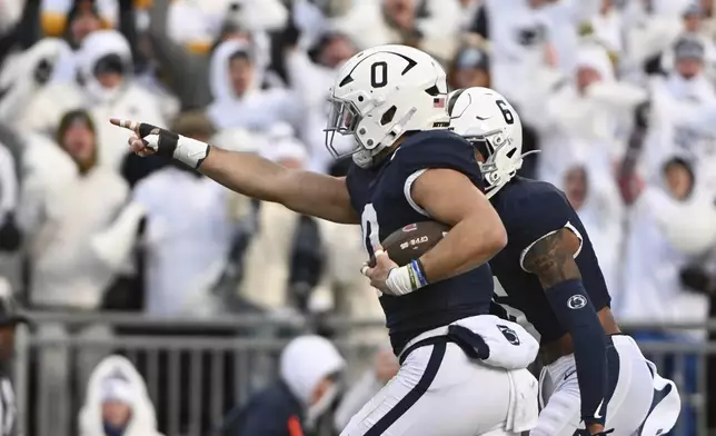 Penn State linebacker Dominic DeLuca celebrates an interception for a touchdown against SMU during the first half in the first round of the NCAA College Football Playoff, Saturday, Dec. 21, 2024, in State College, Pa. (AP Photo/Barry Reeger)