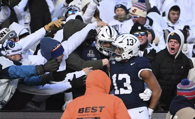 Penn State linebacker Tony Rojas celebrates an interception for a touchdown with Abdul Carter against SMU during the first half in the first round of the NCAA College Football Playoff, Saturday, Dec. 21, 2024, in State College, Pa. (AP Photo/Barry Reeger)