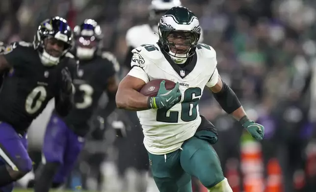 Philadelphia Eagles running back Saquon Barkley (26) runs with the ball against the Baltimore Ravens during the second half of an NFL football game, Sunday, Dec. 1, 2024, in Baltimore. (AP Photo/Stephanie Scarbrough)